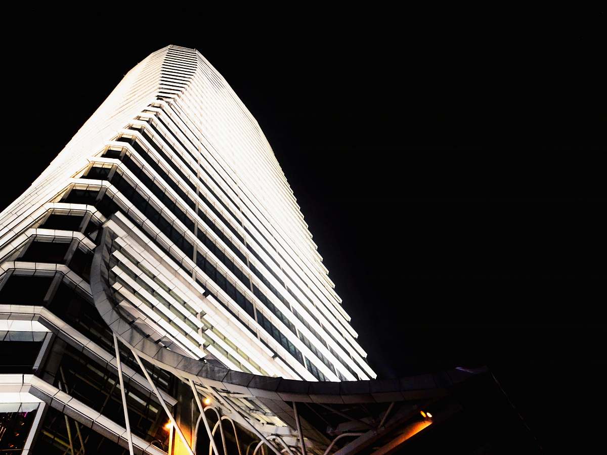 high rise low angle photography of concrete building at nighttime architecture